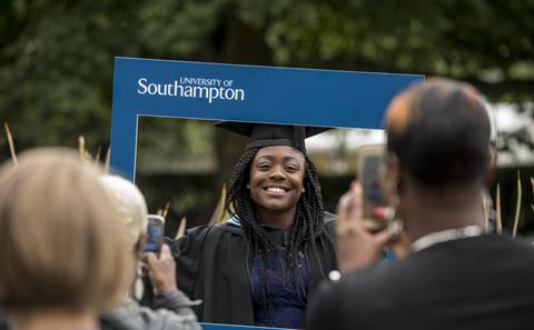 Student posing for photo at their graduation