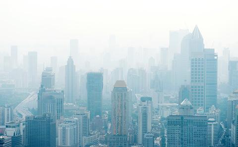 Looking down on a smoggy city skyline.