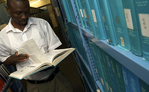 Student with book in Hartley library