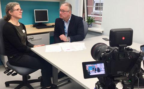 Photo showing two researchers being filmed.