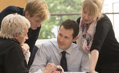 4 people around a meeting table