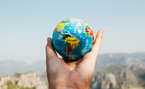 A globe, held in someone's palm.