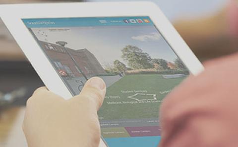 Person looking at virtual tour on tablet screen.