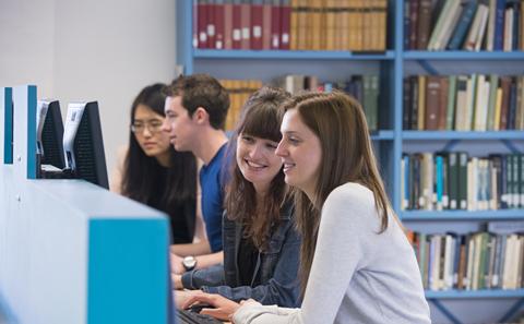 Students using computers in a library