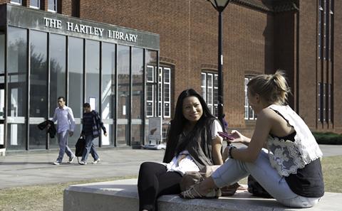 Students sat outside Hartley Library.