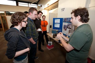 TEAtime participants discussing space junk with an astronautics PhD student