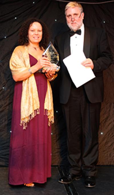 June Crump receiving her award from Tony Acland