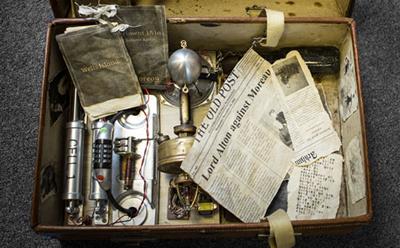 A suitcase containing an assortment of clues