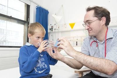 A respiratory specialist conducts a study with a young volunteer.