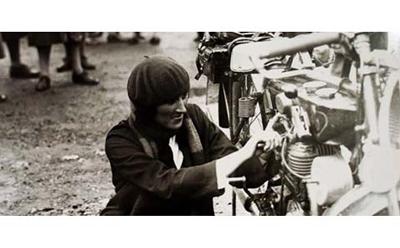 Woman mending a  motor bike