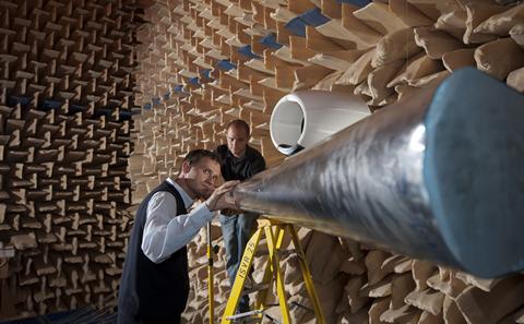 Two academics examining equipment.