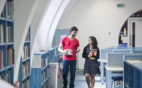 Students walking in the library