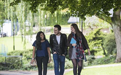 Three students walking on campus