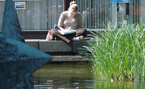 Student writing in a notebook