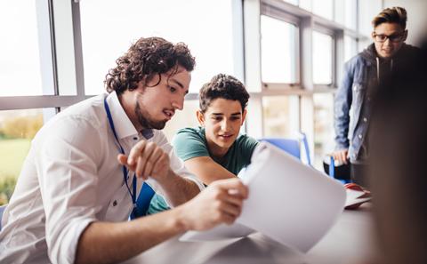 Students reading paper