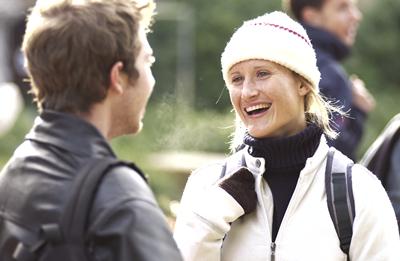 Woman in hat smiling at man