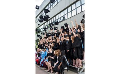 Graduates throwing hats up