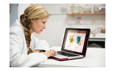 Dr Katie St John Glew on a laptop