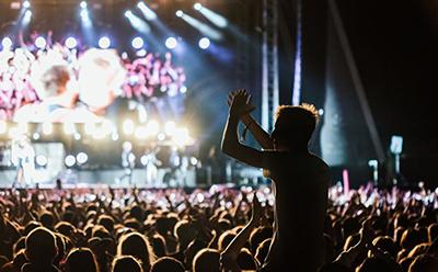 Crowd dancing near a stage at night