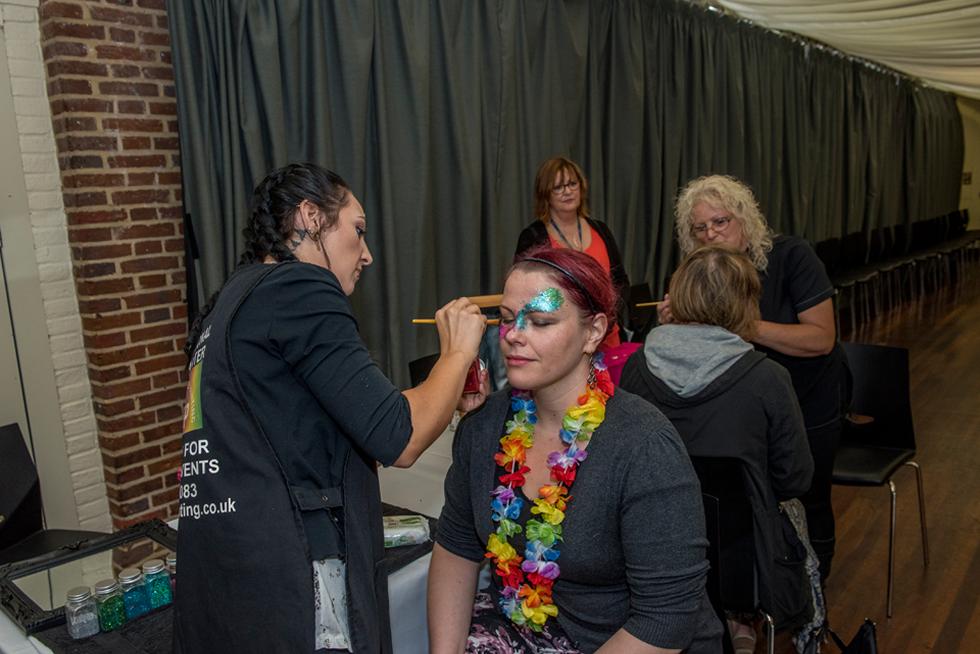 Staff member having their face painted