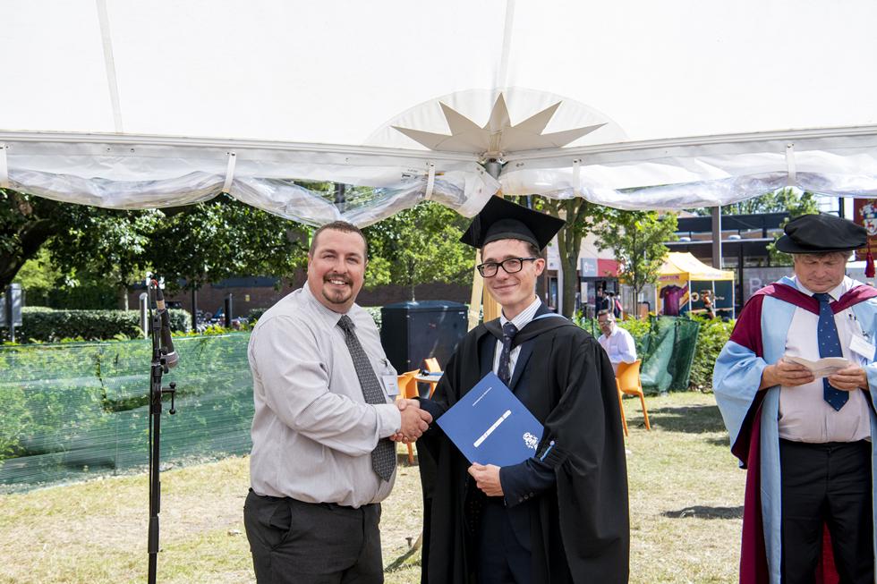 Student receiving graduation certificate  