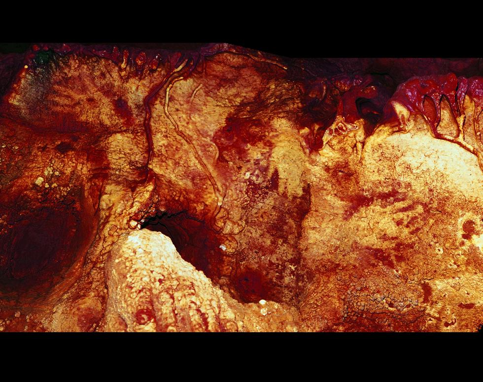 Colour enhanced image of three Neanderthal hand stencils.