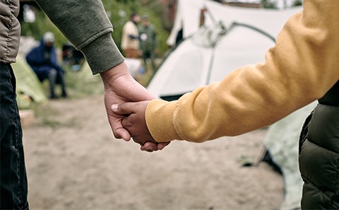 Refugees holding hands