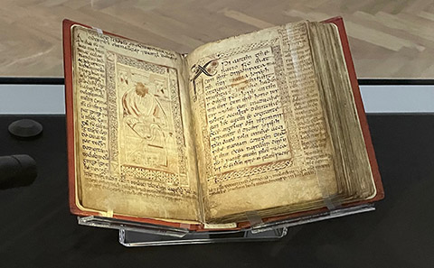 Ancient book of Gospels on museum stand