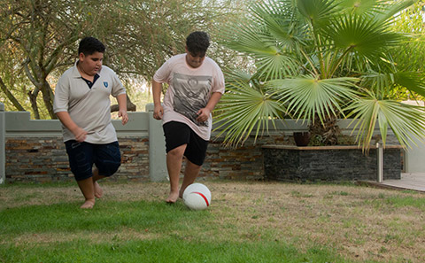 Two boys playing football