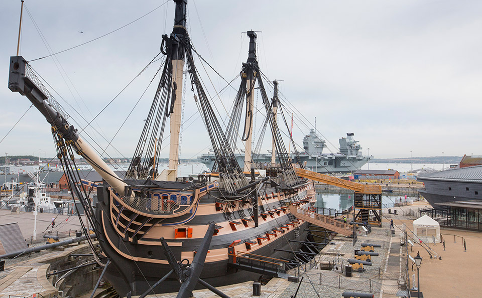 HMS Victory in Portsmouth with HMS Queen Elizabeth behind. Credit: NMRN