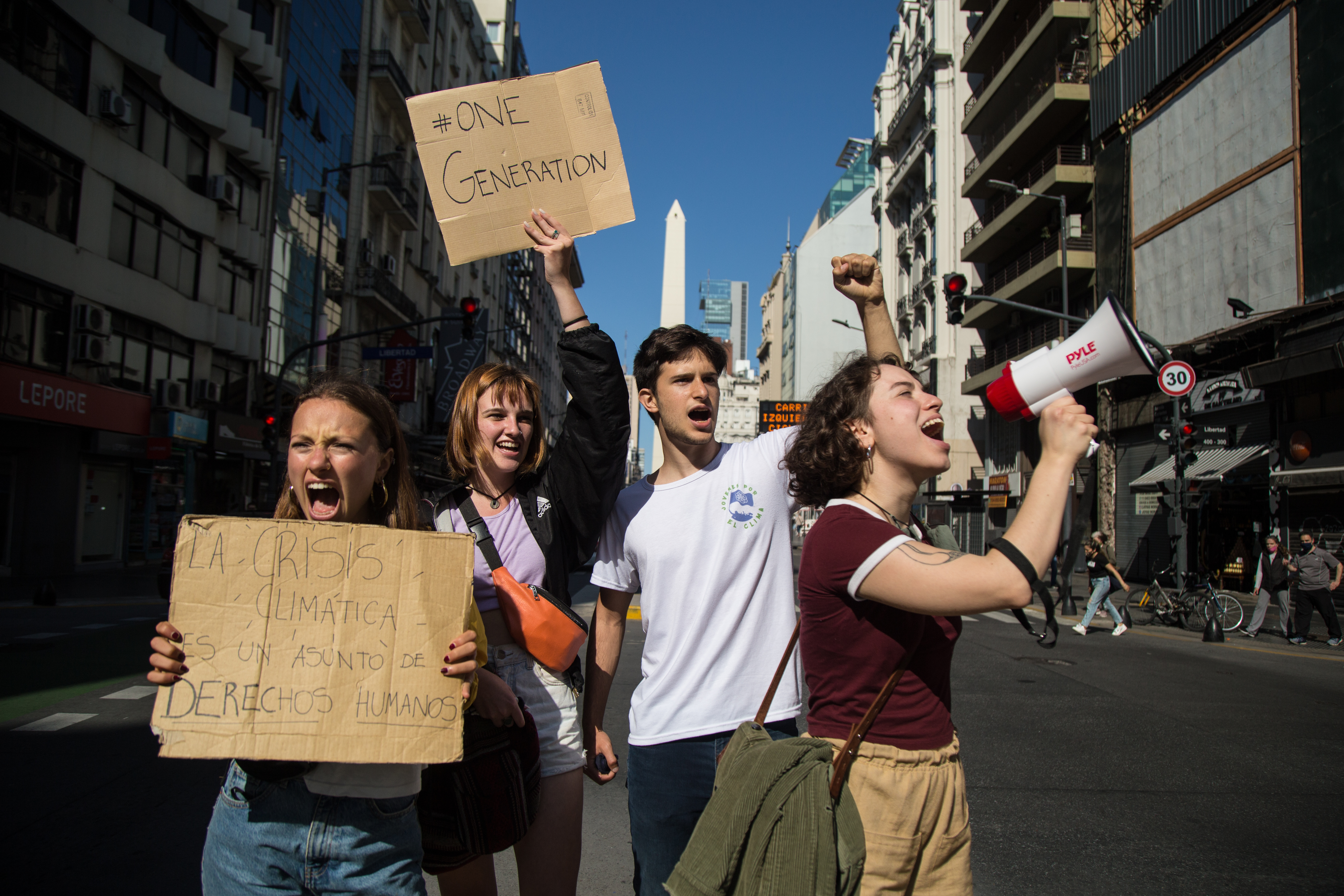 Young people holding cards and protesting in street