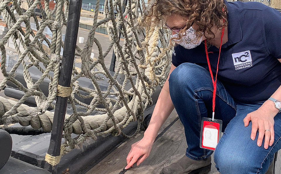 Rachel Triggs examining the deck of HMS Victory.