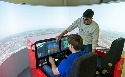 Man sat in flight simulator cockpit