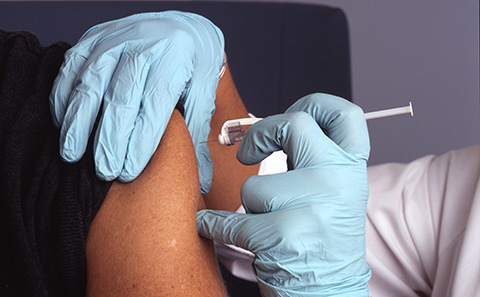 Vaccination needle going into arm