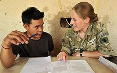 A bristish army female soldier teaching an adult student
