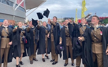 Several British army personal on their graduation day at University