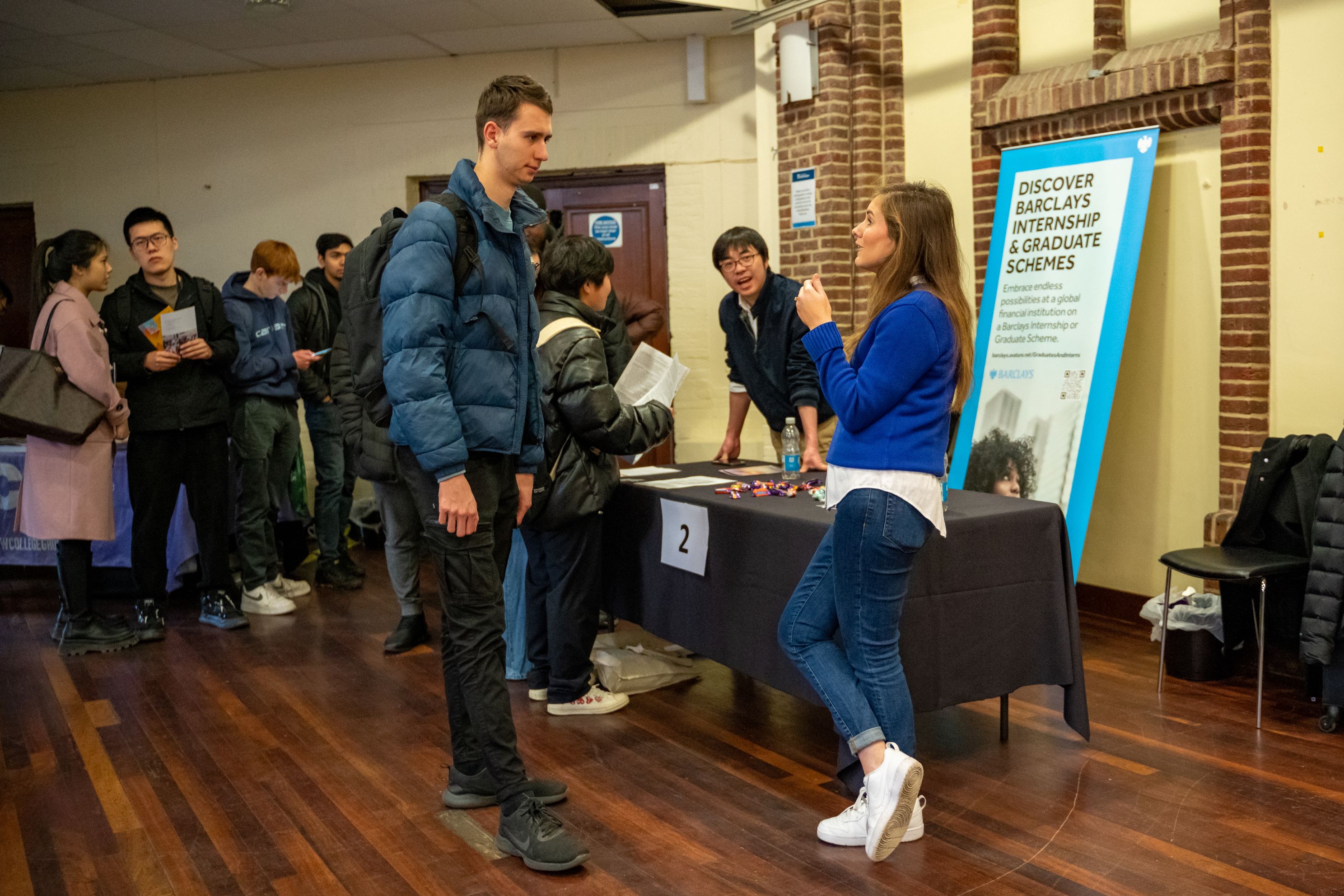 Students talking with advisors at a graduate event