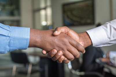 A close-up of two people shaking hands, signifying a sucessful professional relationship