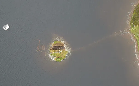 An aerial view of a crannog in Scotland.