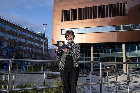 Freda Stevenson holding a Medal