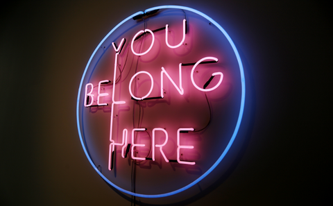 Neon sign reads: YOU BELONG HERE