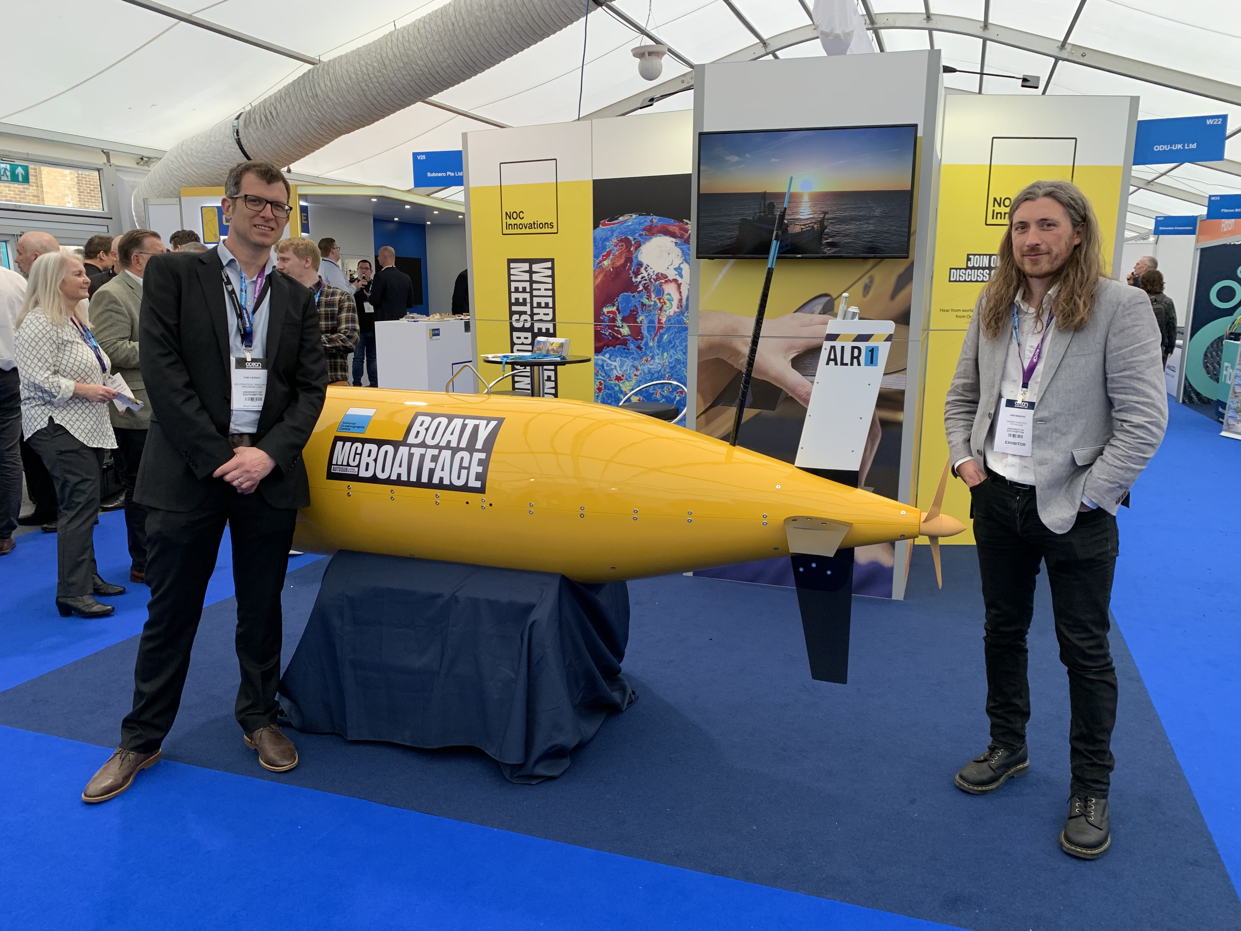 Tom Carnay and Sam Simmons at the NOC Innovations stand with Boaty McBoatface