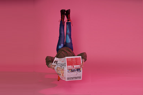 Reading newspaper upside down