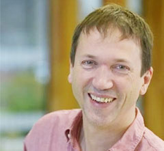 Professor Ivo Tews headshot smiling at camera.