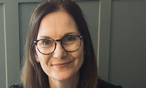 Professor Maggie Donovan-Hall headshot, smiling at camera.
