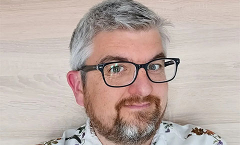 Mark Chapman smiling at camera.