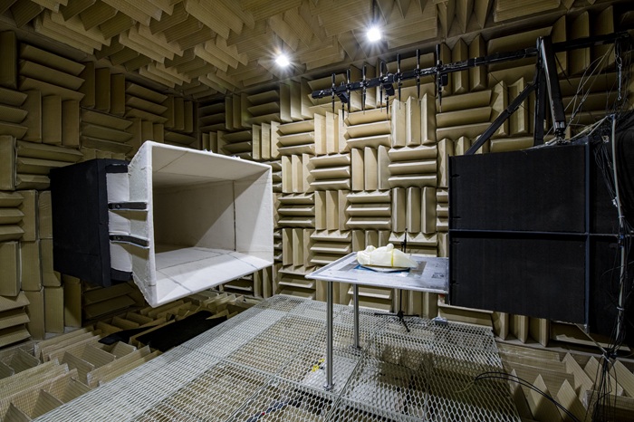 Anechoic chamber with acoustic absorption panels, loudspeakers and test equipment for aeroacoustic research