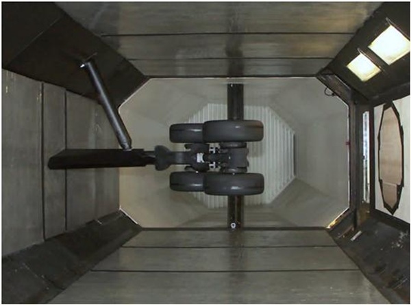 Aircraft landing gear model mounted in the test section of a wind tunnel for aerodynamic research