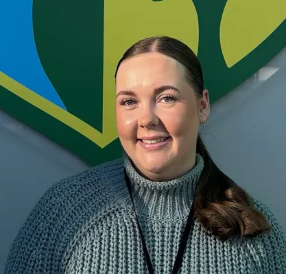 Head and shoulders portrait image of Emma-Louise Doncom smiling at the camera.