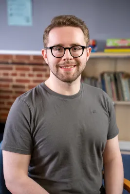 Nick sat smiling for a picture.